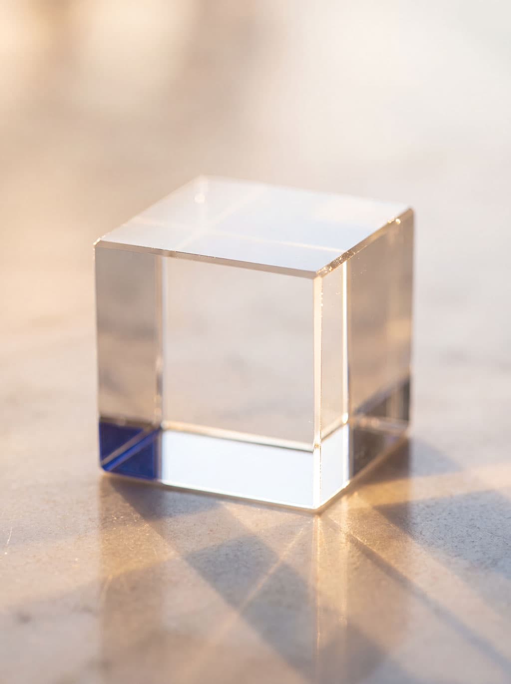 A clear glass cube, lit from within